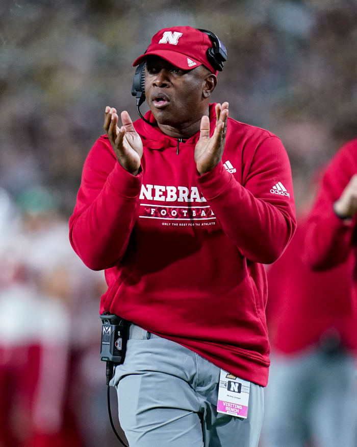 Mickey Joseph coaches along the sidelines for Nebraska.